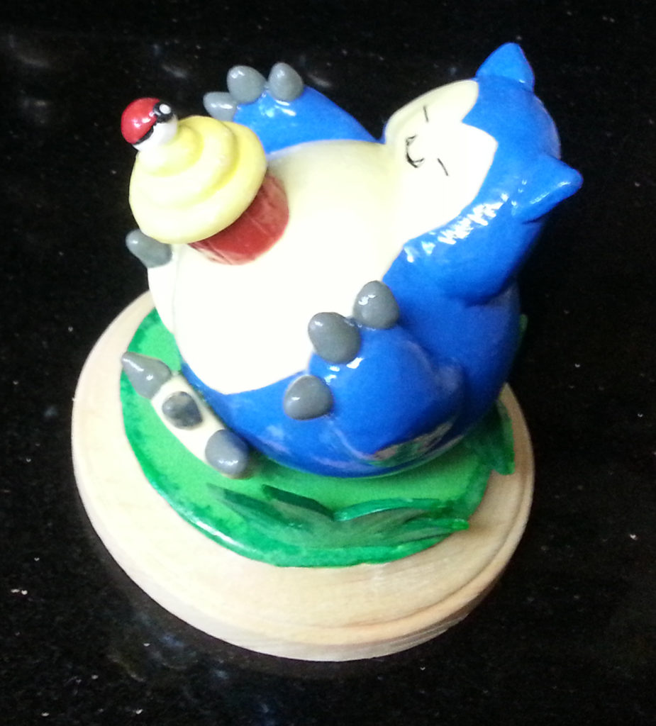 Snorlax Figurine Display on Wooden Plake